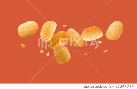 Potato chips flying on a red background. 85344774