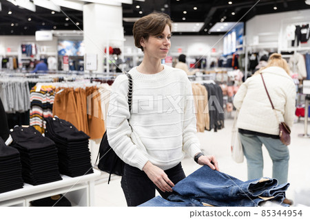 A young beautiful and attractive brunette woman with a short hair in a casual and stylish white 85344954