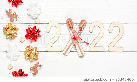Wooden 2022 numbers on White background. Creative concept of Xmas and New Year 85345400