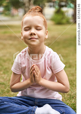 Pretty face. Red hair. Cute school child doing yoga exercise. Active vacation 85348146