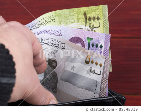 Syrian money in the black wallet. Syrian money in the black wallet. 85348319