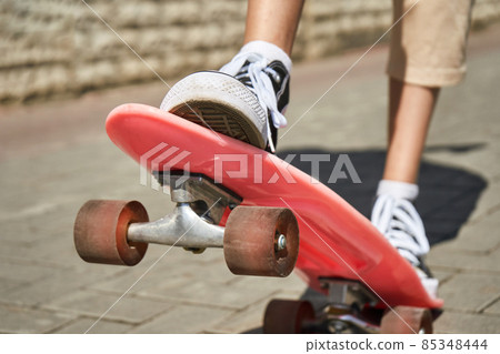 Girl with skateboard. Town landscape. Black sneakers. New normal travel Girl with skateboard. Town landscape. Black sneakers. New normal travel 85348444