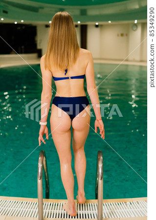 Portrait of beautiful woman in swimwear relaxing in swimming pool spa. Portrait of beautiful woman in swimwear relaxing in swimming pool spa. 85349290