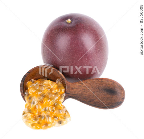 Passion fruits seeds in wooden spoon, isolated on white background. Passionfruit or maracuya pulp, exotic fruit. Passion fruits seeds in wooden spoon, isolated on white background. Passionfruit or maracuya pulp, exotic fruit. 85350009