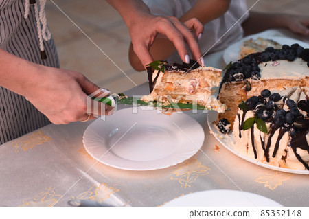 a cut piece of cake is placed on a plate. 85352148