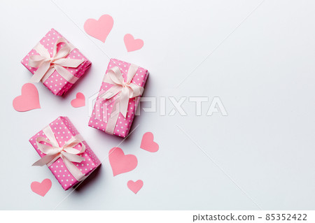 Valentine day composition: red gift box with bow and heart. Christmas present. View from above. Space for text. Holday greeting card Valentine day composition: red gift box with bow and heart. Christmas present. View from above. Space for text. Holday greeting card 85352422