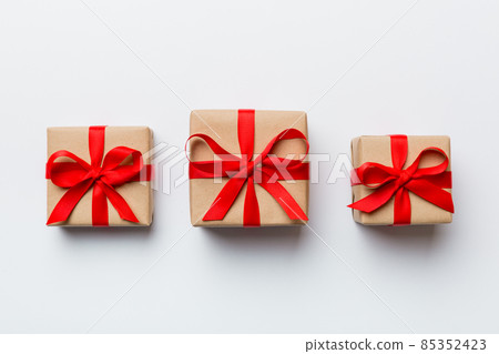 Valentine day composition Background: red gift box with bow and heart. Christmas present. View from above. Holday greeting card Valentine day composition Background: red gift box with bow and heart. Christmas present. View from above. Holday greeting card 85352423