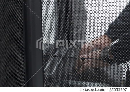 Close up on Data Center Engineer hands Using keyboard on a supercomputer Server Room Specialist Facility with Male System Administrator Working with Data Protection Network for Cyber Security. Close up on Data Center Engineer hands Using keyboard on a supercomputer Server Room Specialist Facility with Male System Administrator Working with Data Protection Network for Cyber Security. 85353797