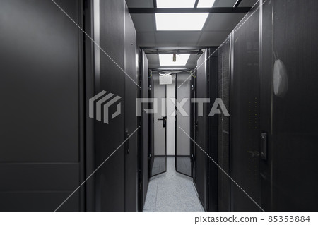 Data Center With Multiple Rows of Fully Operational Server Racks. Modern Telecommunications, Cloud Computing, Artificial Intelligence, Database, Supercomputer Technology Concept. Data Center With Multiple Rows of Fully Operational Server Racks. Modern Telecommunications, Cloud Computing, Artificial Intelligence, Database, Supercomputer Technology Concept. 85353884