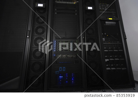 Data Center With Multiple Rows of Fully Operational Server Racks. Modern Telecommunications, Cloud Computing, Artificial Intelligence, Database, Supercomputer Technology Concept. Data Center With Multiple Rows of Fully Operational Server Racks. Modern Telecommunications, Cloud Computing, Artificial Intelligence, Database, Supercomputer Technology Concept. 85353919