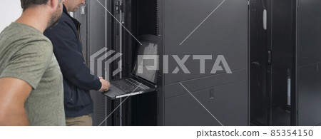 Technicians team updating hardware inspecting system performance in super computer server room or cryptocurrency mining farm. 85354150