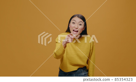 Furious adult arguing in front of camera, raising finger in frustration 85354323