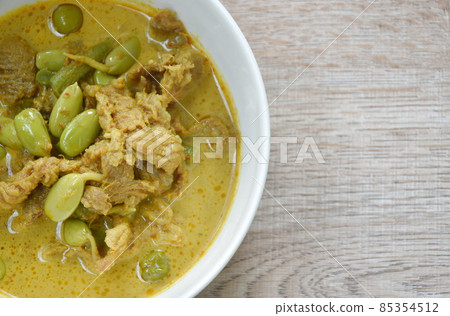 spicy boiled pork and Nitta tree seed or luk rieng in coconut milk curry soup Thai southern food on bowl 85354512