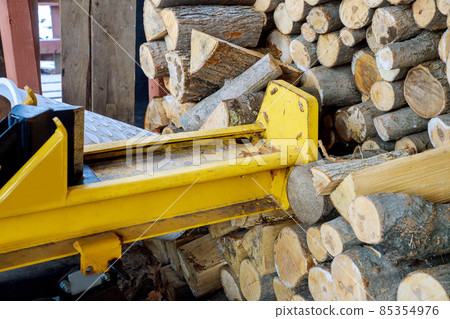 Splitter machine with person splitting firewood 85354976