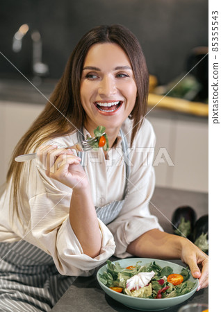Cute positive woman in the kitchen Cute positive woman in the kitchen 85355543