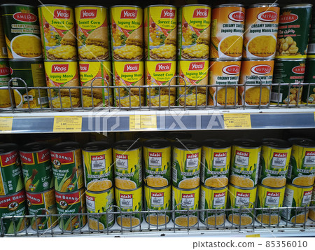 SEREMBAN, MALAYSIA - JUNE 4, 2021: Selected focused on sweet corn that has been canned in commercial packaging. Already available cooked. Sorted by brand and has a price tag. 85356010