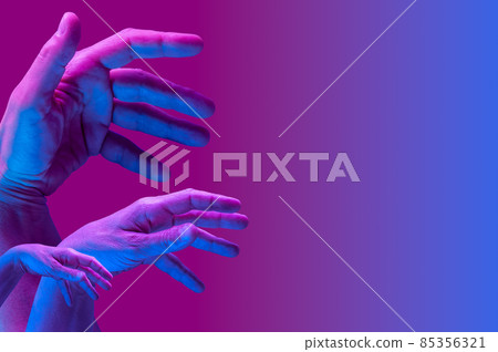 Hands in a surreal style in violet blue neon colors. Modern psychedelic creative element with human palm for posters, banners, wallpaper. Copy space for text. Magazine style template. Pop art culture. Hands in a surreal style in violet blue neon colors. Modern psychedelic creative element with human palm for posters, banners, wallpaper. Copy space for text. Magazine style template. Pop art culture. 85356321
