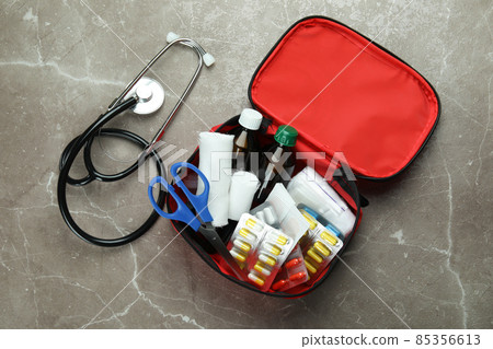 First aid medical kit on gray textured background 85356613