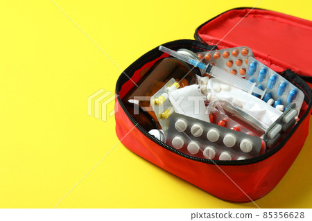 First aid medical kit on yellow background First aid medical kit on yellow background 85356628
