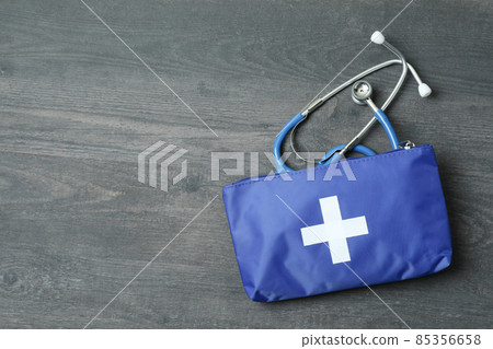 First aid medical kit on dark wooden background First aid medical kit on dark wooden background 85356658