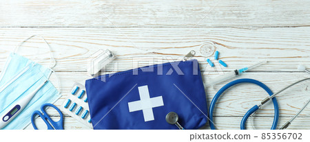 First aid medical kit on white wooden table First aid medical kit on white wooden table 85356702
