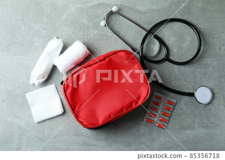 First aid medical kit on gray textured table 85356718