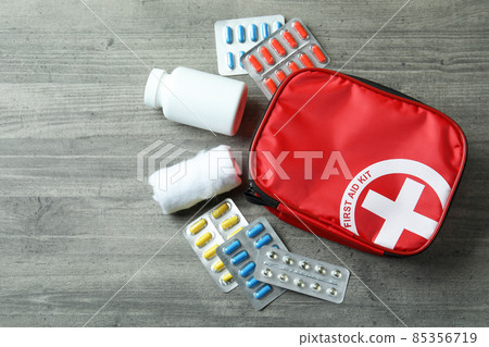 First aid medical kit on gray textured table 85356719