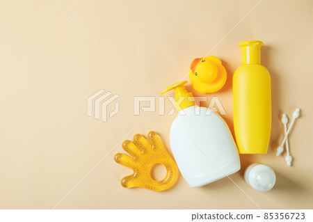 Different baby hygiene accessories on beige background Different baby hygiene accessories on beige background 85356723
