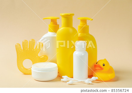 Different baby hygiene accessories on beige background 85356724