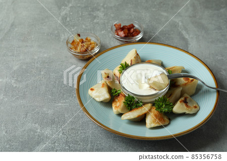 Concept of tasty food with vareniki or pierogi on gray textured background Concept of tasty food with vareniki or pierogi on gray textured background 85356758