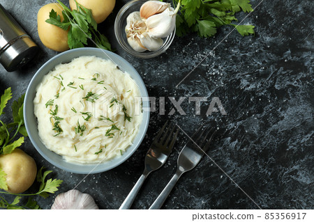 Concept of tasty eating with mashed potatoes on black smokey table Concept of tasty eating with mashed potatoes on black smokey table 85356917