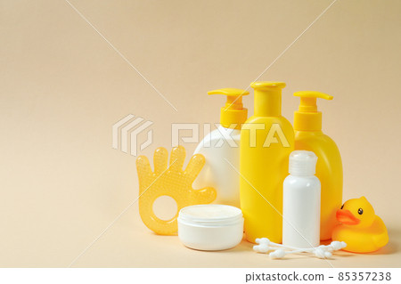 Different baby hygiene accessories on beige background Different baby hygiene accessories on beige background 85357238