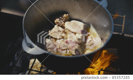 cook food on a camping trip in nature, fry meat according to a recipe in a pot over a fire, stew a meat dish on a trip, boiling broth in a saucepan, boiled ready-made stew, meat abundance of protein 85357285