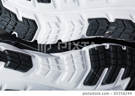 The black and white sole of trendy sports sneakers is a close-up in full screen. The black and white sole of trendy sports sneakers is a close-up in full screen. 85358244