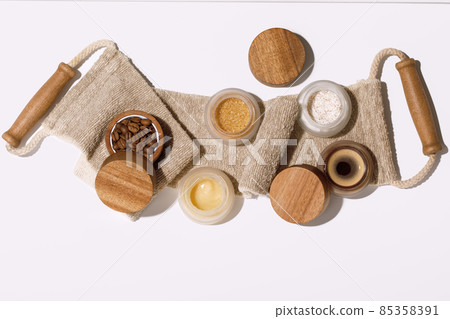 Brown sugar, coffee and honey ingredients for scrub in glass jars with wooden lid on exfoliating body strap for homemade cosmetic. Beauty, Spa, skin care, aromatherapy. Brown sugar, coffee and honey ingredients for scrub in glass jars with wooden lid on exfoliating body strap for homemade cosmetic. Beauty, Spa, skin care, aromatherapy. 85358391