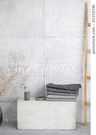 Organic waffle linen towels, bamboo toothbrushes, bathroom zero waste accessories in grey shades in contemporary bathroom interior. Daily body care, spa and wellness zero waste bathroom concept 85358396