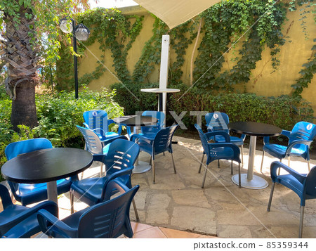Empty Chairs And Tables At Cafe In City Empty Chairs And Tables At Cafe In City 85359344