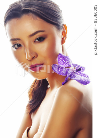 young pretty asian woman with flower purple orchid isolated on white background, spa people concept 85360005