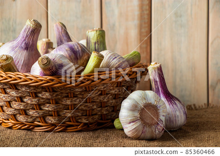 Fresh purple aromatic garlic on a rustic wooden background. Ingredient for cooking. 85360466