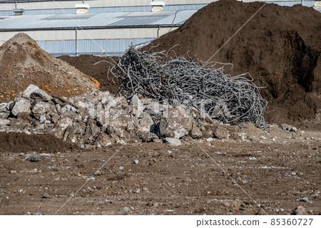Soil, rubble and rebar scraps at a demolition site 85360727