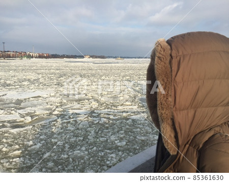 A woman wearing a down jacket hood 85361630