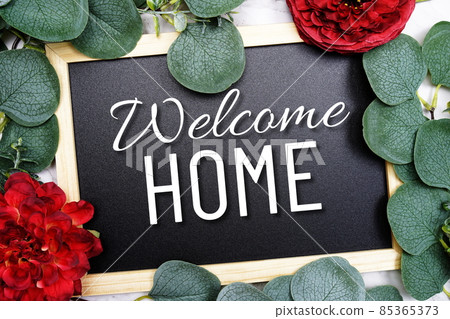 Welcome Home text on blackboard and eucalyptus leaves decoration on marble background 85365373