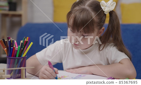 little girl draws with crayons in sketchbook, concept of children's creativity, child draws with bright colorful pencils sitting table home, conceptual baby dream to be an artist, to learn fantasize little girl draws with crayons in sketchbook, concept of children's creativity, child draws with bright colorful pencils sitting table home, conceptual baby dream to be an artist, to learn fantasize 85367695