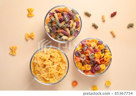 Different types of pasta on beige background, flat lay 85367734