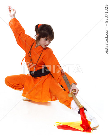 Wushu-Girl dressed in orange make exercise of Shaolin taolu 85371329