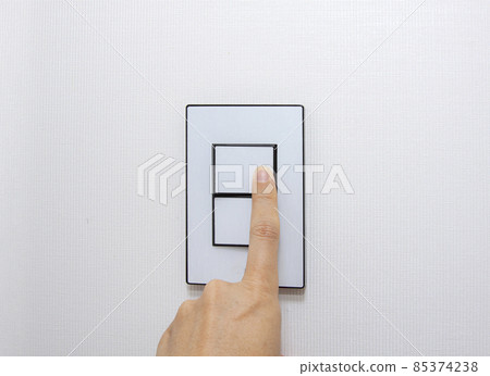 hand pushing a switch 85374238