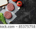 Raw homemade grill beef burgers with salad and tomatoes. 85375758