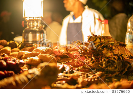Zanzibari night street food market in Forodhani Gardens. Stone Town, Zanzibar City, Unguja island, Tanzania 85376660