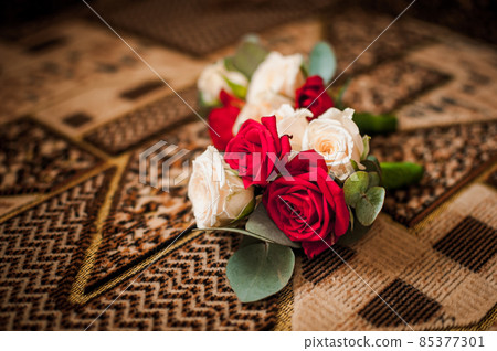 Colorfull bouquet of flowers lying on the carpet Colorfull bouquet of flowers lying on the carpet 85377301