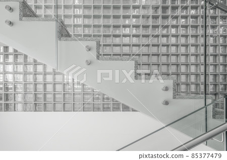Transparent walls and staircase in modern building against wall with glass square tiles. Transparent walls and staircase in modern building against wall with glass square tiles. 85377479